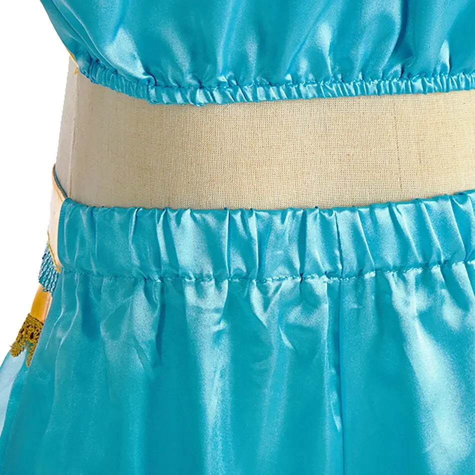 detailed view of teal and gold princess outfit showing embroidered bodice and soft mesh fabric